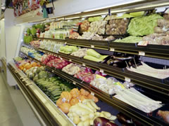 Photo shows a store display case of organic produce.